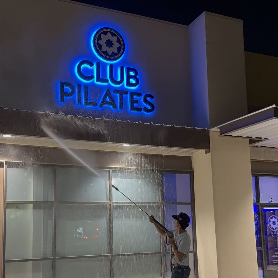 Velo Property Solutions pressure washing the storefront at Club Pilates in Phoenix